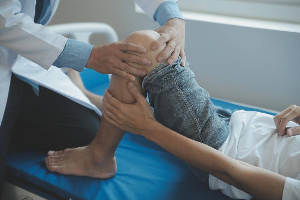 An orthopaedic specialist checking patient